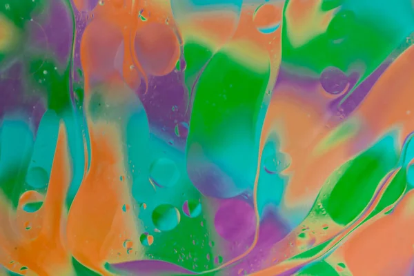 vegetable oil colored bubbles above water
