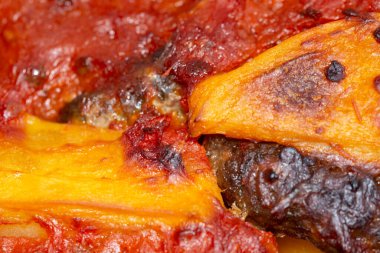 Meatballs and potatoes close-up in a pot. vertical top view