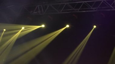 Sahne ışıkları çerçevesinin animasyonu. Parlak sahne ışıkları yanıp sönüyor. Karanlık, yeşil ışık projektörlerindeki spot ışıkları siyah arka plana vuruyor..