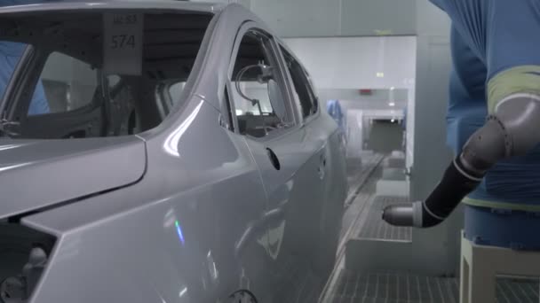 Robotic arms spray painting a vehicle body at a car manufacturing factory — Stock Video