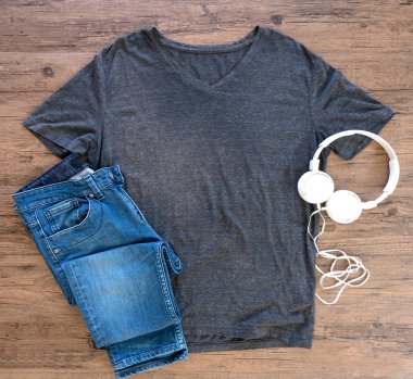 Vintage T-shirt mock up  with headphone flat lay on wooden background. Top vie
