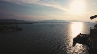 Hava görüntüsü. Nehir limanında dev vinçlerin siluetleri.