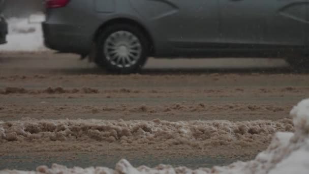 Міські дороги під час сильних снігопадів. Автомобілі проїжджають через зимовий бруд і сніг — стокове відео