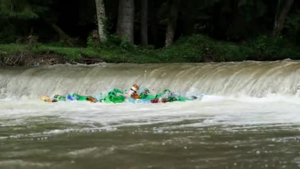 Ecological disaster of water resources. Plastic bottles and trash in the river water. — Stock Video