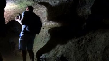 Genç turist bilim adamı mağaranın durumunu araştırıyor..
