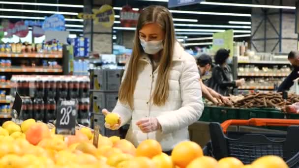 Menina compra limão no supermercado, citrinos, comida saudável. — Vídeo de Stock