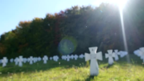 Cemitério com cruzes brancas em um dia ensolarado. — Vídeo de Stock