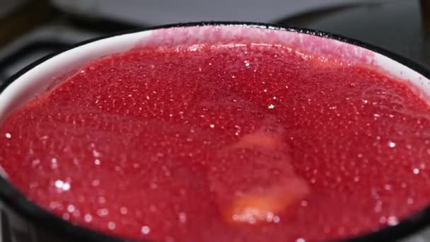 Boiling raspberry jam in a pot, making raspberry jam at home, homemade preserve. — Stock Video
