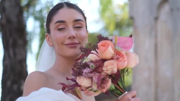 Foto de perfil de close-up de uma noiva admirando um buquê de flores. — Vídeo de Stock