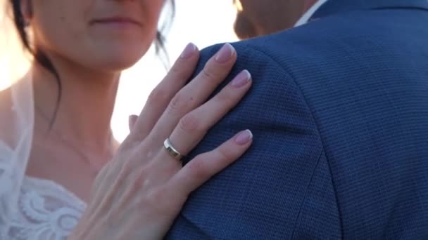 Eine Frauenhand mit einem Ring an der Schulter eines Mannes. Hochzeit, Verlobung. — Stockvideo