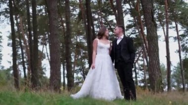 Parkta duygularını ifade eden genç ve seksi bir çift. Gelin ve damat dışarıda öpüşüyor..