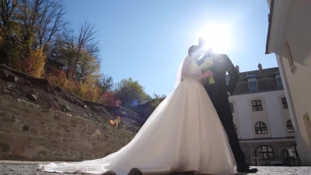 Wedding couple walking in the old town. The young couple is in love — Stock Video