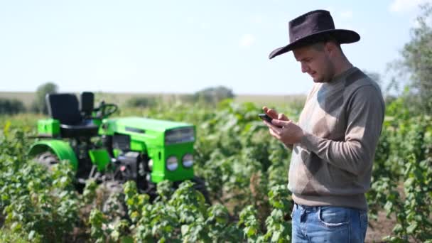 Agribusiness ve Spojených státech, Colorado, venkovský pracovník odpočívající poblíž jeho traktoru — Stock video