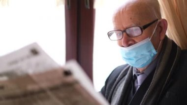 Yaşlı büyükbaba bir kafede otururken basını okuyor. Emekli dinleniyor.