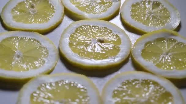 Sappige citroenschijfjes, slow motion, macro. gesneden roterende citroenschijfjes. — Stockvideo