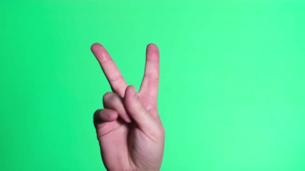 Two fingers up on the chromakey screen. Gesture of victory — Vídeo de stock