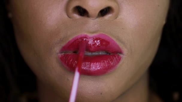 Közelkép afrikai lány festékek ajkak piros rúzs. — Stock videók