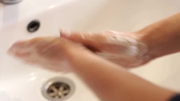 Woman washes her hands in the bathroom with water, soap and foam. — Video