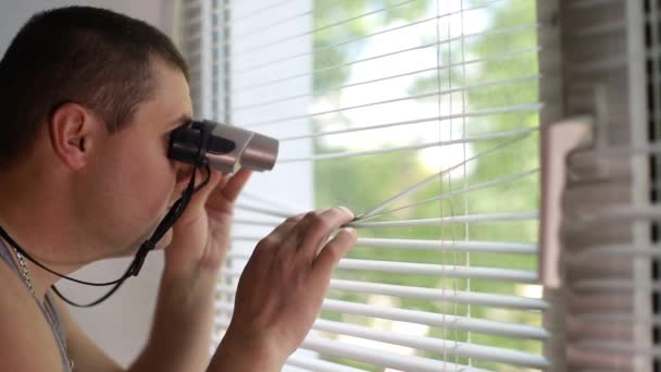 Man spying on people, using binoculars for observation — 비디오