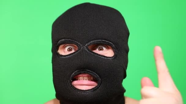 Scary thief or robber in mask looking at camera. — Stock Video