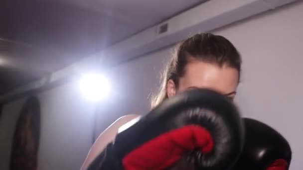 Girl boxer hits the camera with gloves. Boxing training. — 비디오