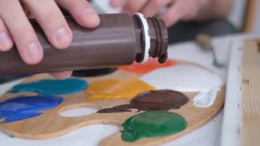 Super slow motion 240 fps, creative artist paints an abstract picture with colorful paints. 