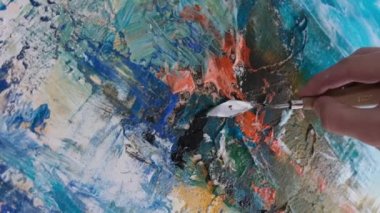 Super slow motion 240 fps, the artist paints an abstract picture in the studio.