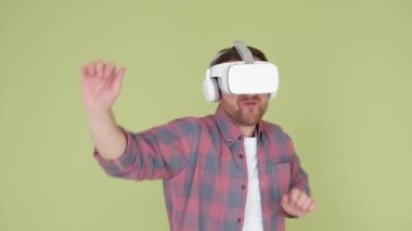 An adult man in vr glasses with 3D virtual reality, he is having fun and dancing.