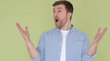 The young European is shocked and shocked by the words WOW, joy on a mans face close up