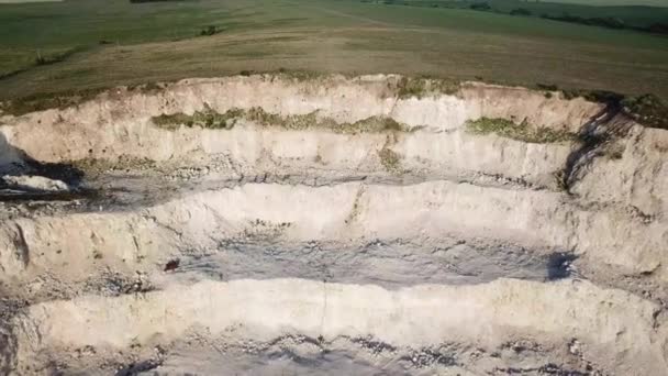Aerial view of open quarry - top view. quarries for construction with blue sky. mineral environment, industry. rural landscape — Stockvideo