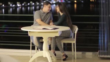 A romantic couple having fun in a cafe, in love with Valentines Day