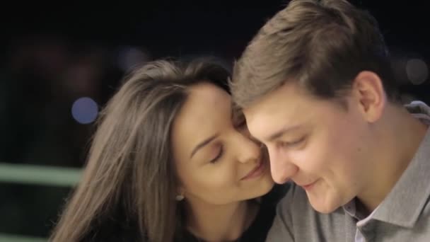 A sweet couple lovers kisses behind the citys lights. Valentines young couple on Valentines day — Video Stock