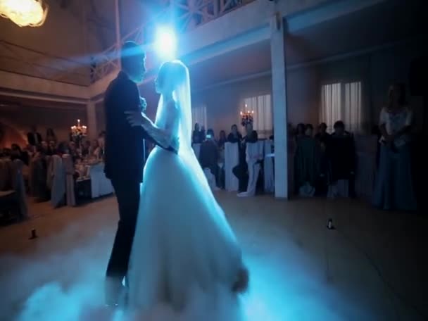 Happy bride and stylish groom dancing at wedding reception. gorgeous wedding couple performing their first dance in restaurant. newlyweds, happy emotional moment. space for text — 비디오