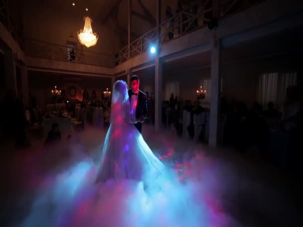 Amazing first wedding dance of newlyweds on low pink light and heavy smoke. Photo with noise — Stock videók