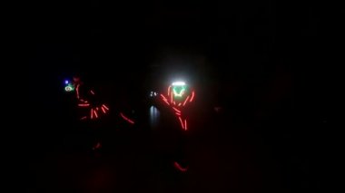 Laser show performance, dancers in led suits with LED lamp, very beautiful night club party.