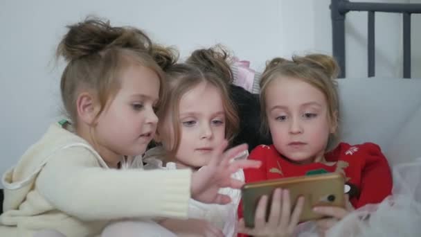Three teenage girls play games on the phone. Dependency on gambling, happy family — Vídeo de stock