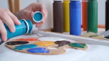 Super slow motion 240 fps, creative artist paints an abstract picture with colorful paints. 