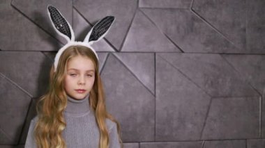 Paskalya tavşanı gibi giyinmiş şirin küçük bir kız. Mutlu bir çocuk tatil için bekliyor.