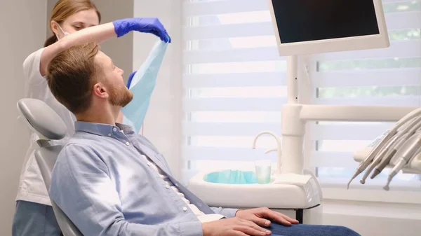 Young European Man Dental Chair Smiles Doctor Brushing Teeth Caries — Stock Photo, Image