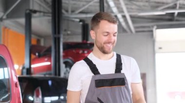 Erkek araba tamircisi öğle arasında anahtarlarla oynuyor. Profesyonel araba servisi ustası. 4k video