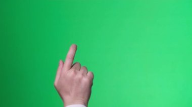 Male hand gestures on green screen: pointing or tapping on the screen. Hand movements on the screen of a chromakey. 4k video