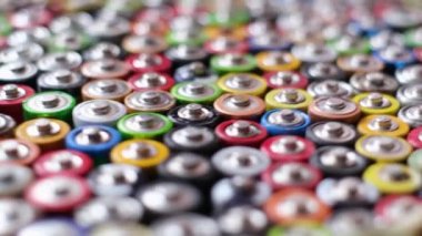 Selective focus, AAA AA batteries and batteries packed close together. Different types of used batteries 