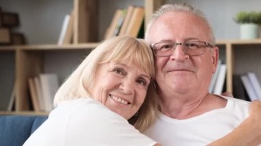 Portrait of an elderly husband and wife in love smiling at the camera. Happy retirement. Care for the health of the elderly