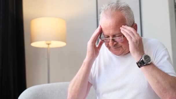 Old Gray Haired Retired Grandfather Sitting Sofa Massaging His Head — Vídeos de Stock