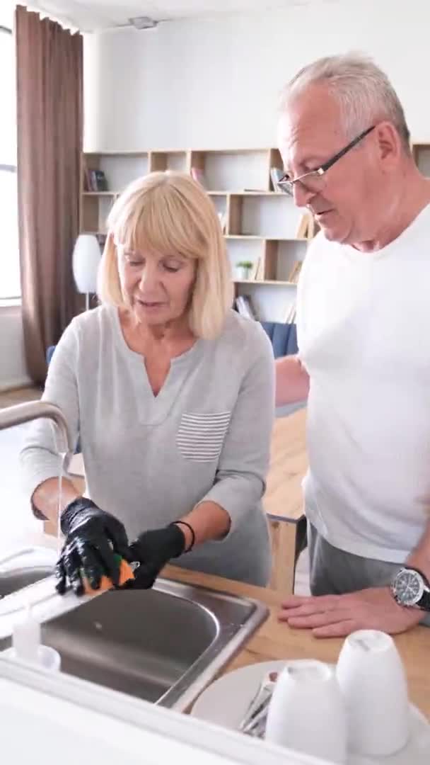 Vertical Position Elderly Woman Washing Dishes Kitchen Talking Her Husband — Wideo stockowe