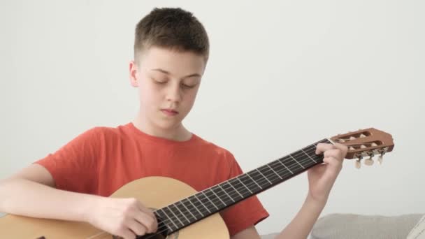 Teenage Boy Plays Guitar Hand Plays Strings Guitar Music Hobby — Vídeo de stock