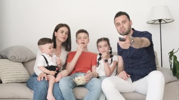 Family Three Children Watching Movie Sitting Sofa Living Room Dad — Stock video