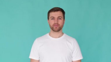 Close up of a surprised man shouting wow and looking at the camera in surprise. Happy young bearded man shocked by the big news. 4k video