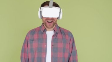 A focused man in a VR headset looks straight ahead. Technology concept. High quality 4k video. Modern virtual reality technologies