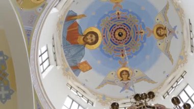 The upper part of the Greek Catholic Church with hand-painted icons. Iconostasis. Icon painting in the church.